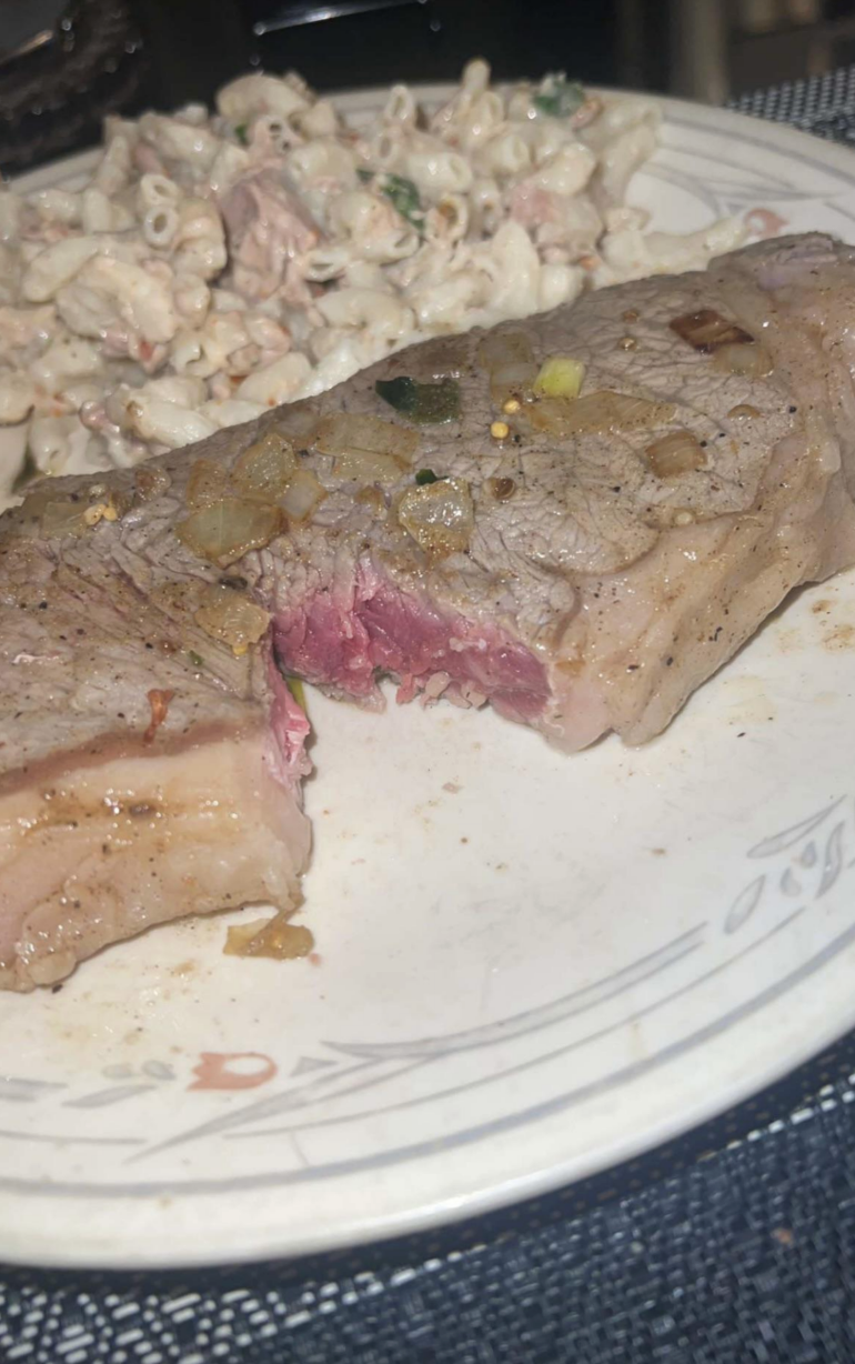The steak has no seer on the outside and is so pink in the middle it looks raw; this would be unsafe to eat