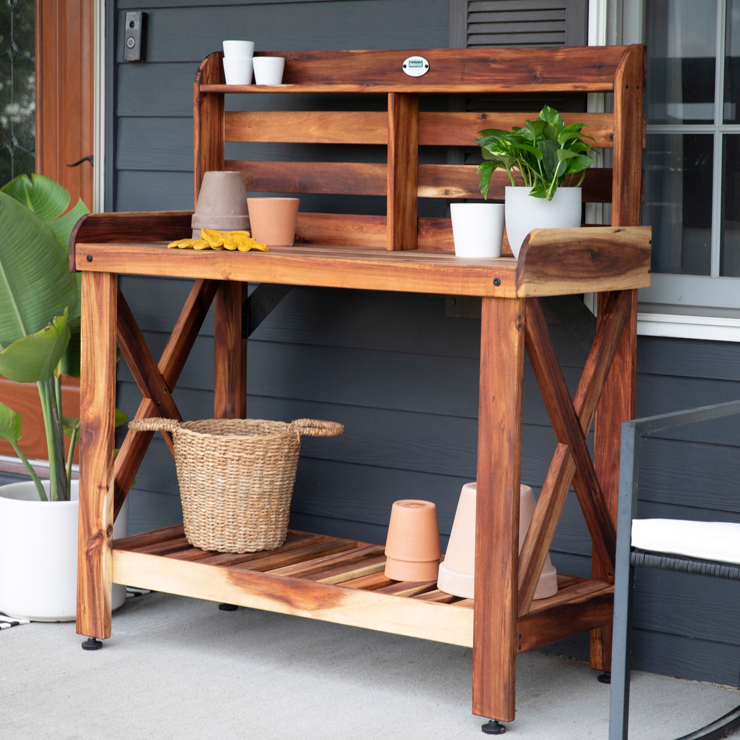 acacia wood potting bench with a bottom shelf, work station, and small top shelf