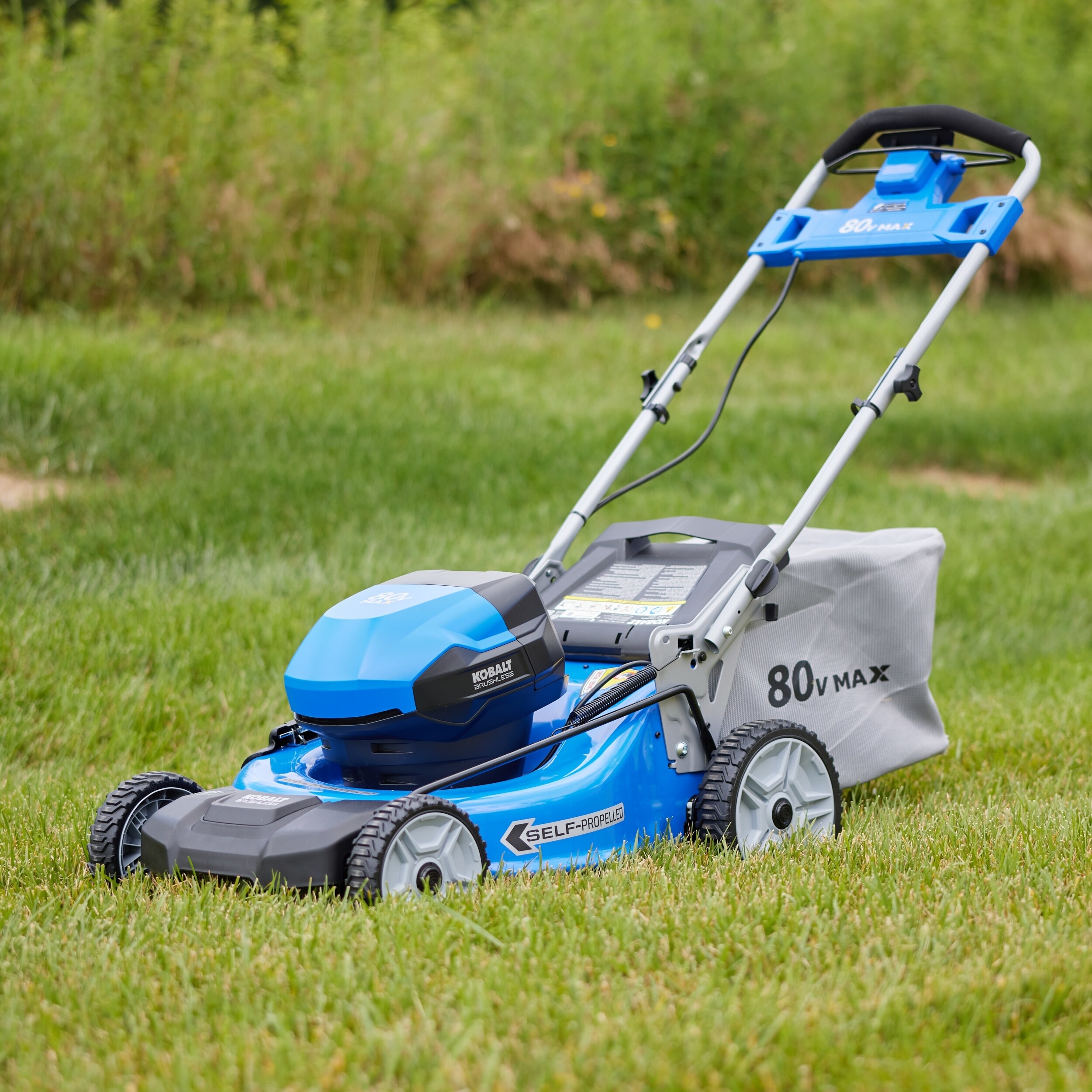 blue electric lawnmower with a bag