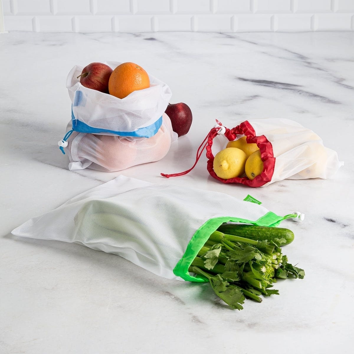 Mesh bags with fruit and vegetables inside.
