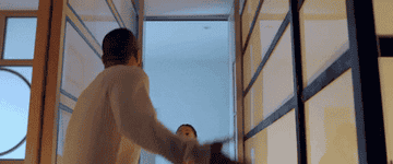 A man and a woman arguing in a hallway