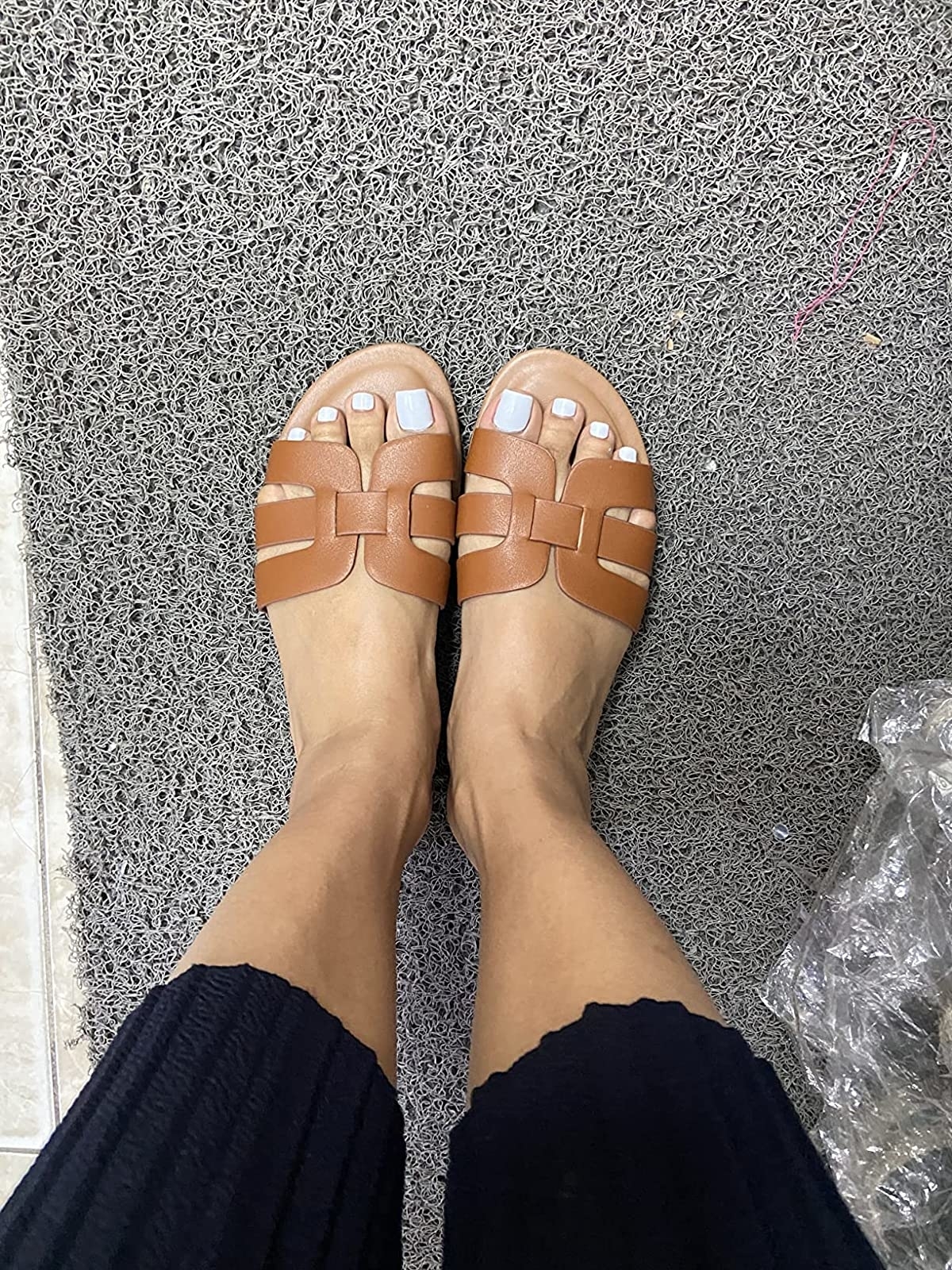 Reviewer wearing the brown sandals