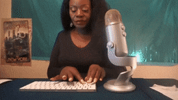 A GIF of a woman typing on a keyboard