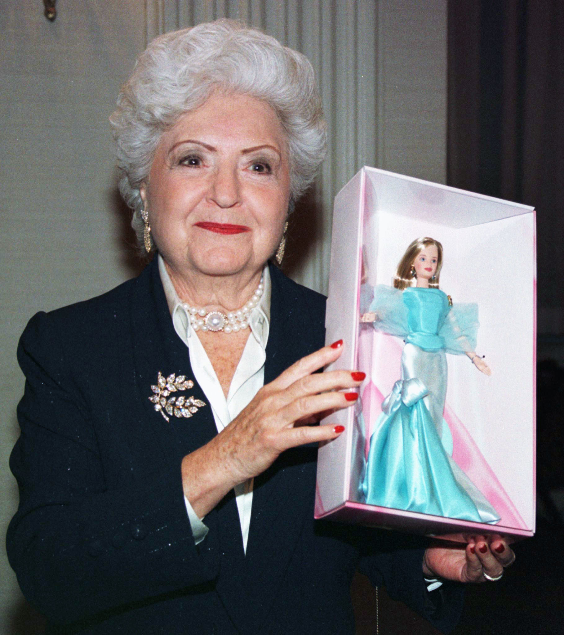 ruth holding up a barbie in her box