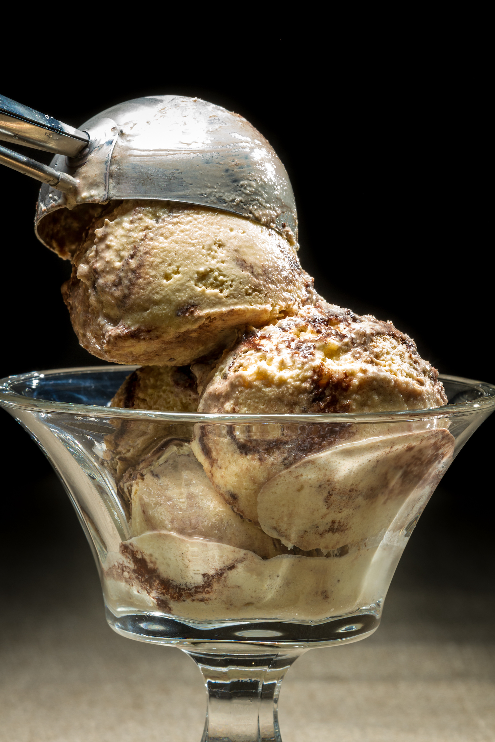 Closeup of ice cream being scooped into a bowl