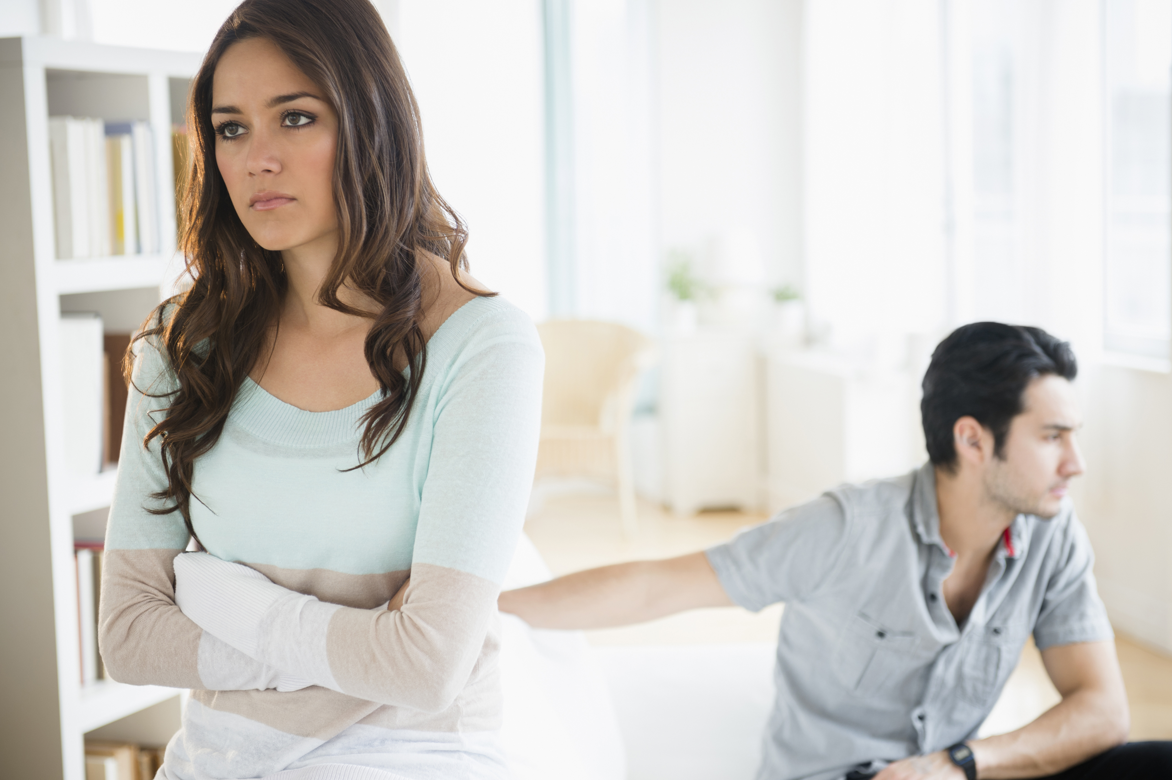 A woman and man in a relationship argue at home