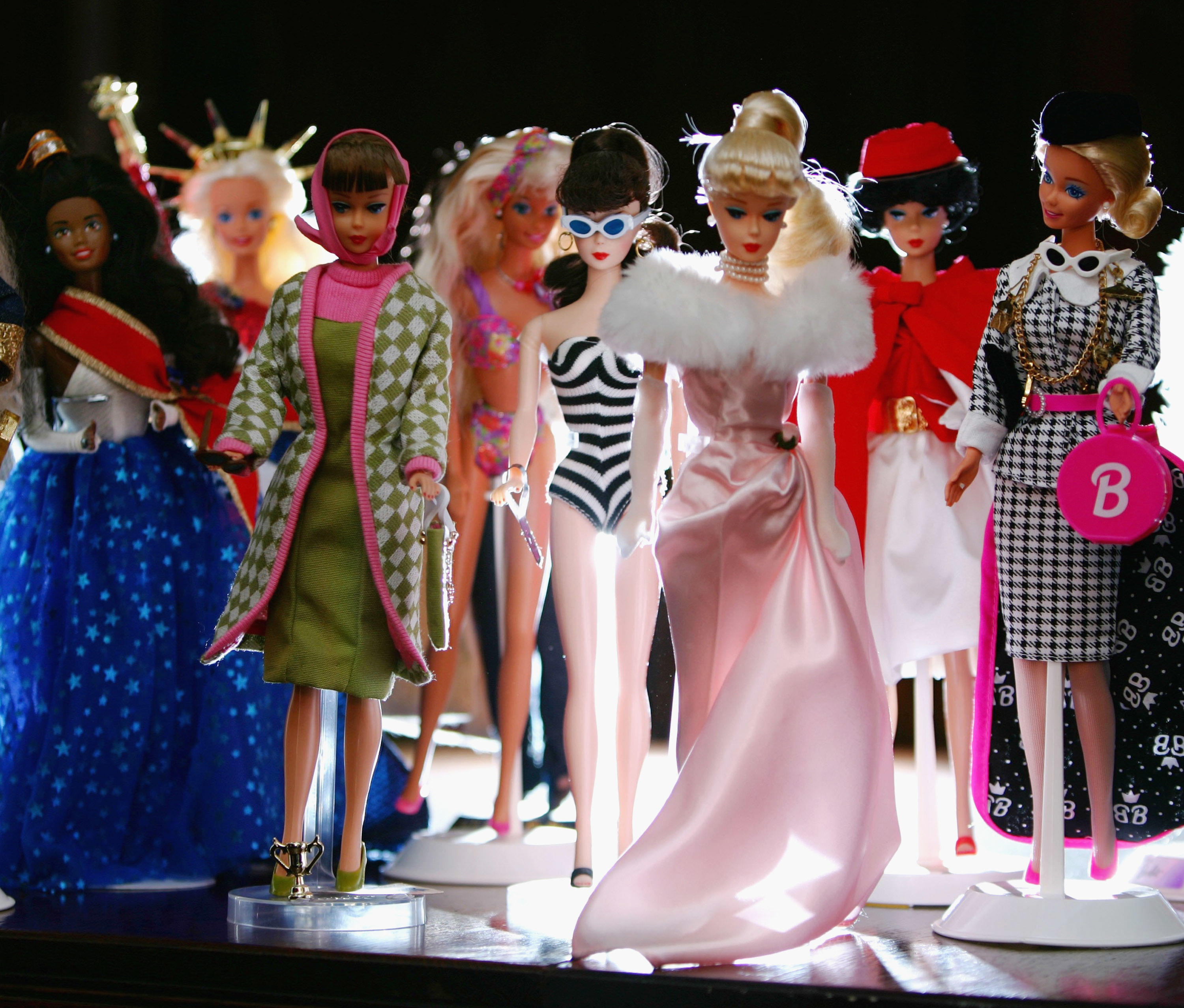line of barbies all in different outfits