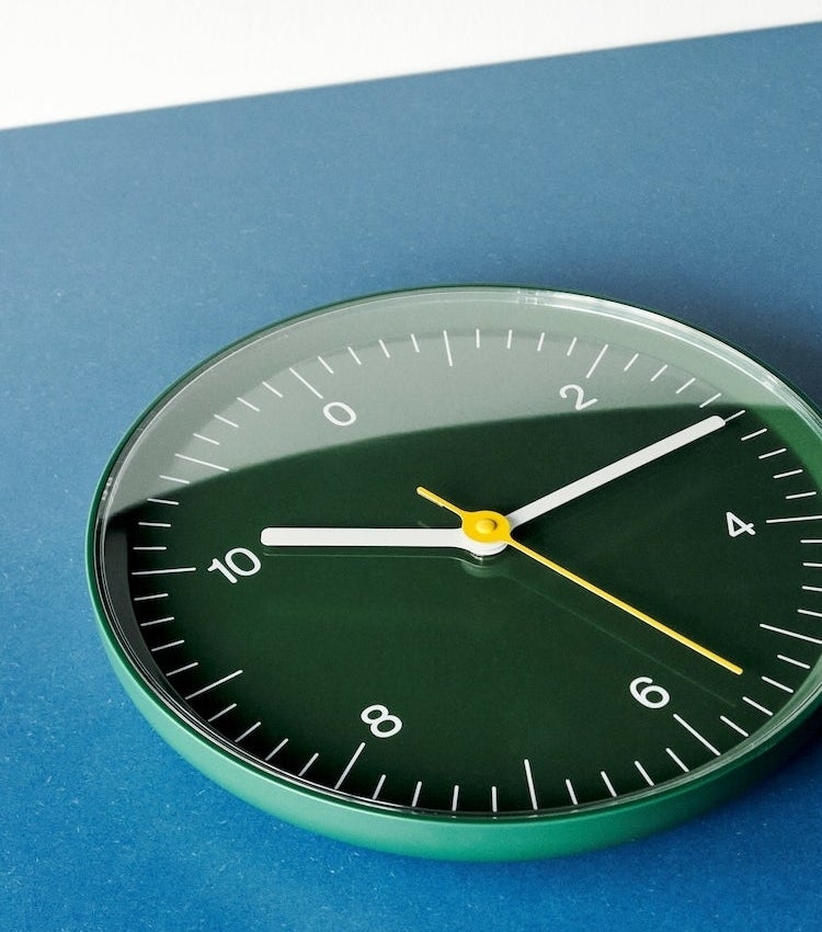 green wall clock with only even numbers labeled
