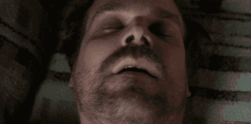 GIF of David Harbour waking up suddenly