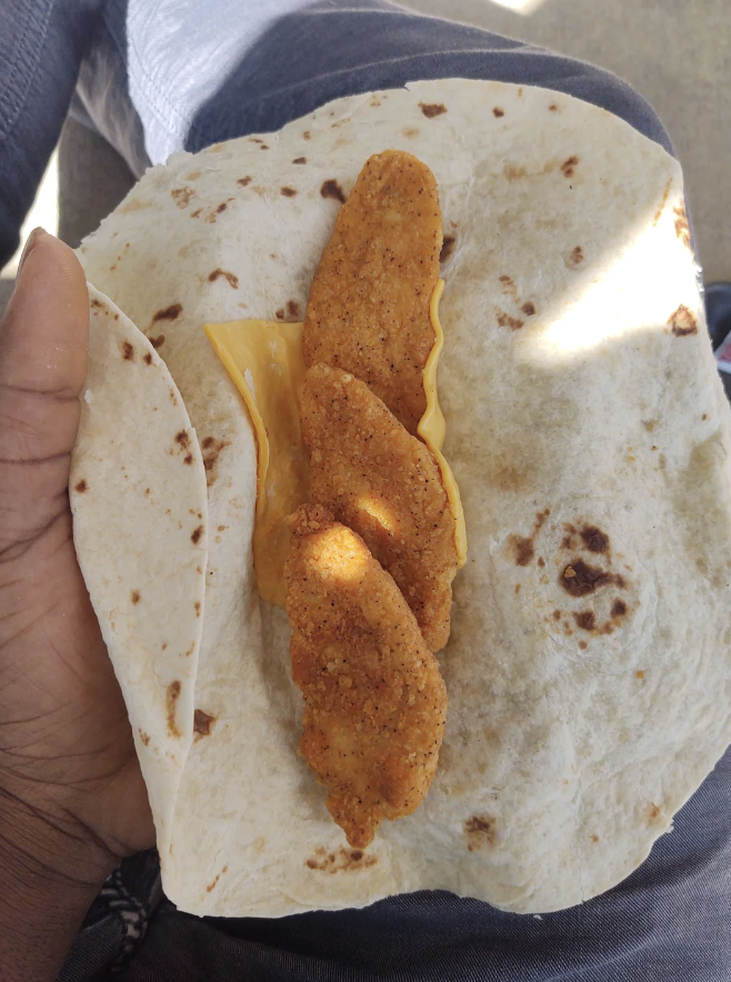 A fried chicken wrap with nothing on it but chicken and cheese