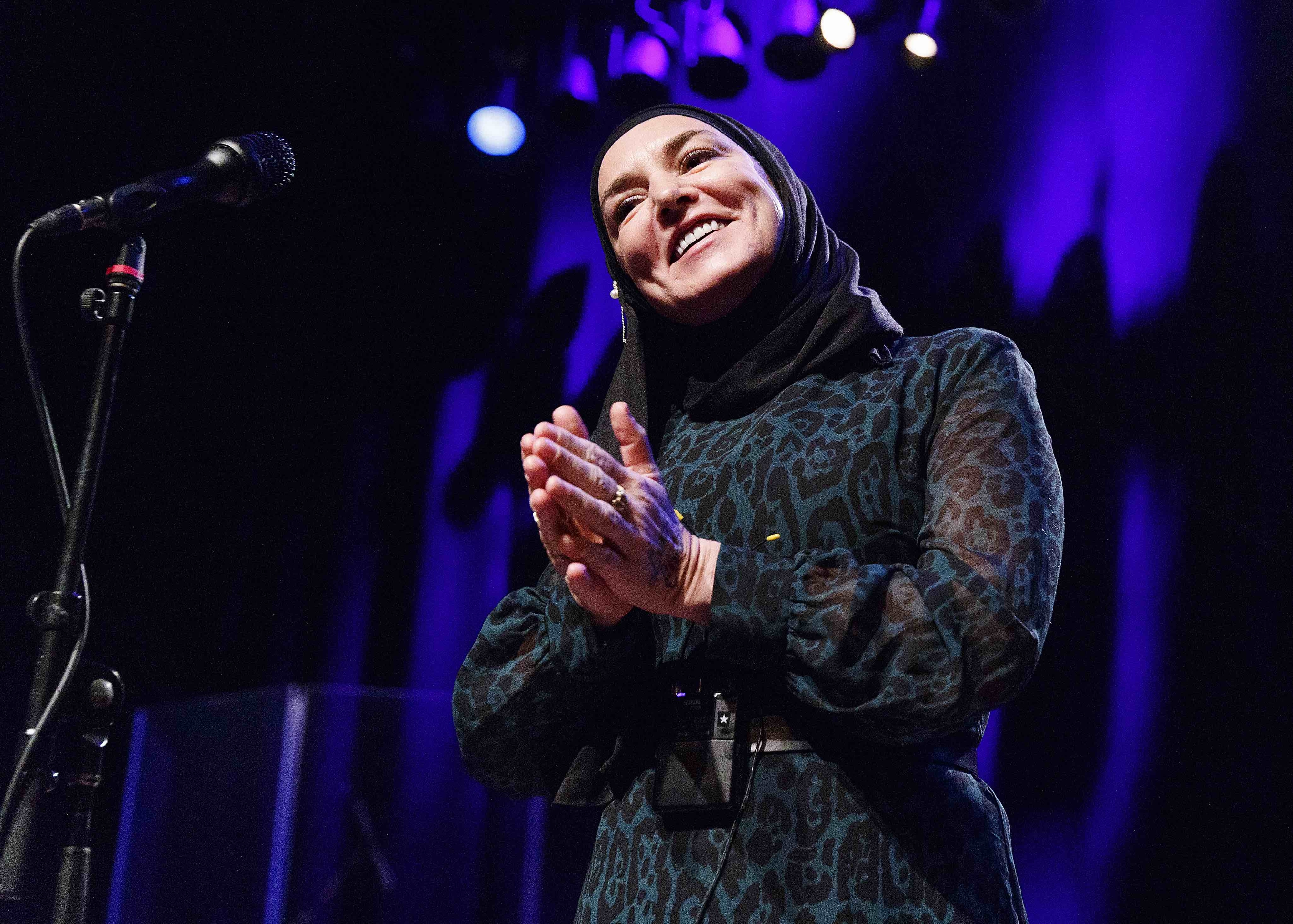 Closeup of Sinéad O&#x27;Connor onstage acknowledging the audience