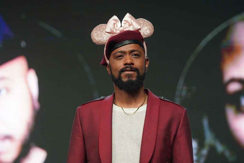 Lakeith doing press for his film wearing a beret and a sequined pair of Minnie Mouse ears on top of that