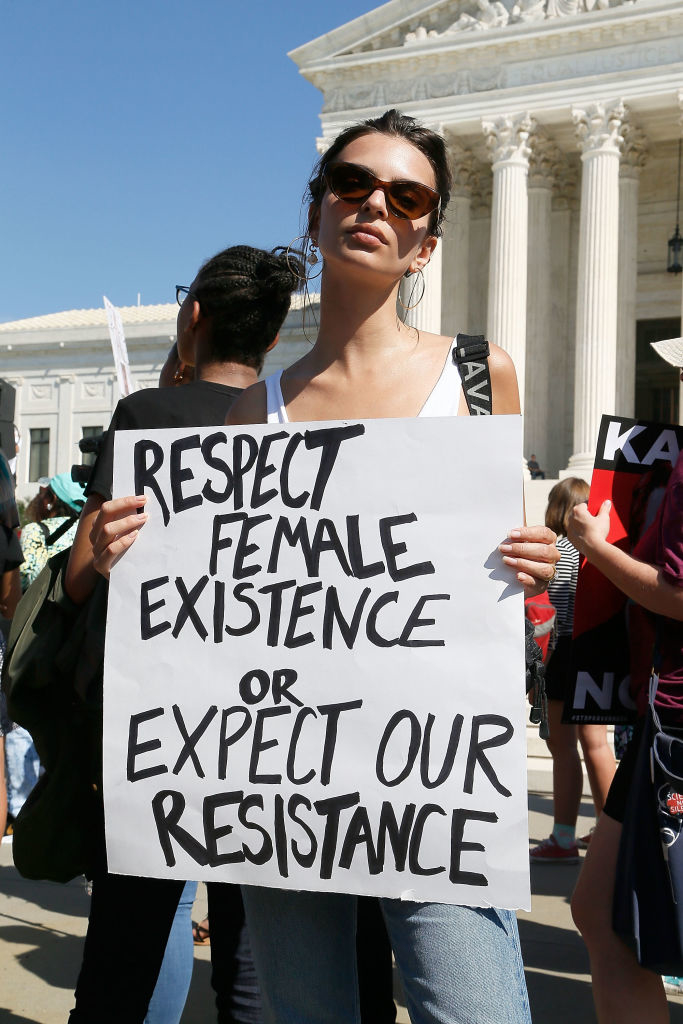Emily Ratajkowski holding a sign and protesting