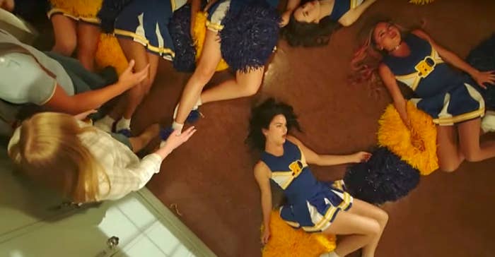 Veronica, Toni and other girls lie on the floor of Riverdale High School, wearing cheerleader outfits. They are all having seizures.