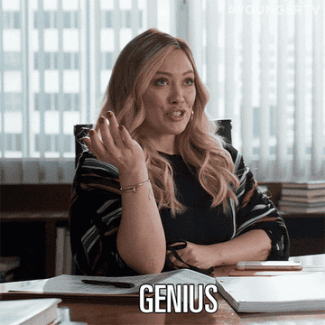 Kelsey from &quot;Younger&quot; sitting at a desk saying &quot;Genius.&quot;