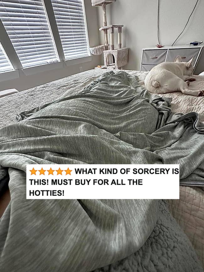 The pale blue cooling blanket with reviewer text 
