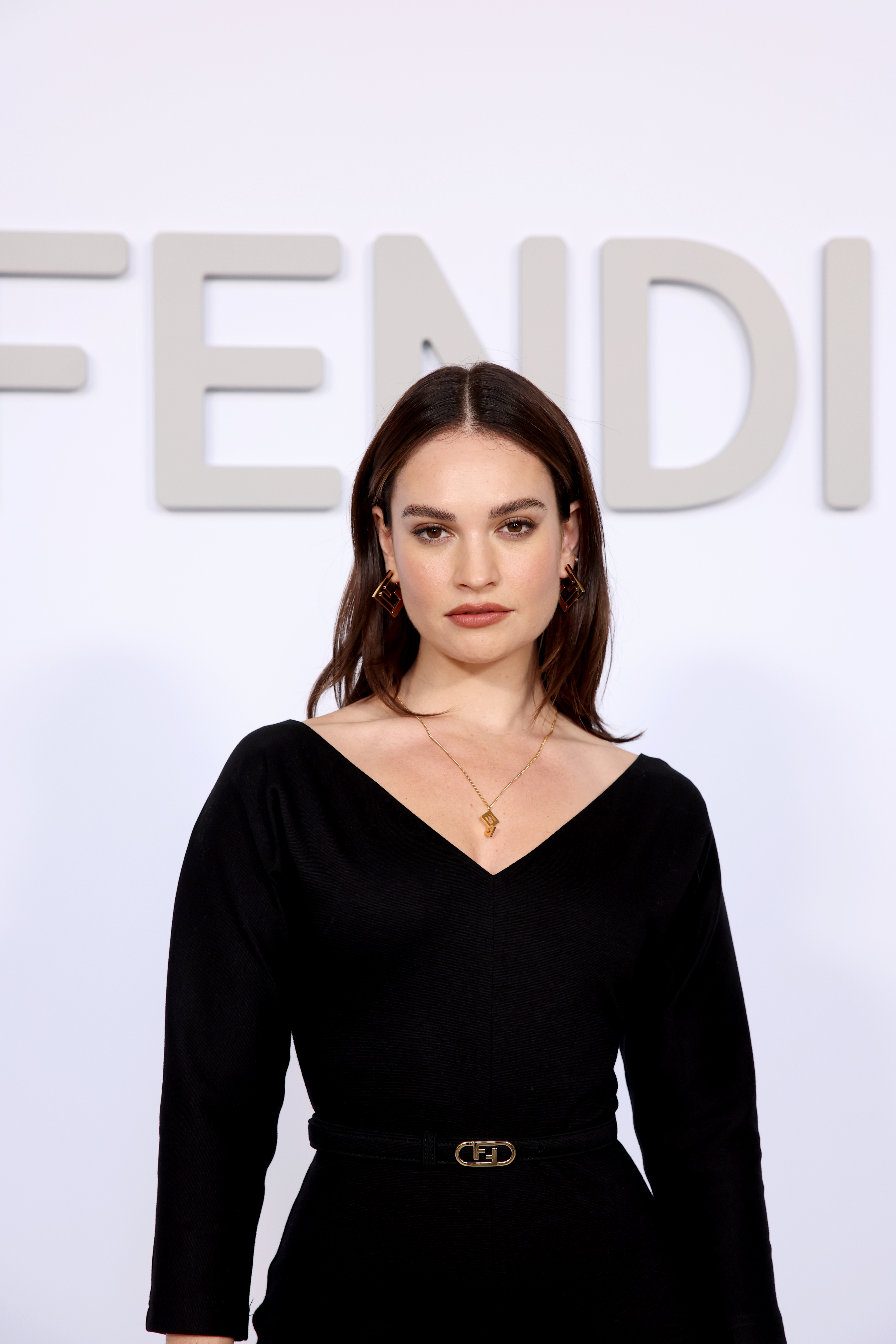 lily james poses for photographers on the red carpet