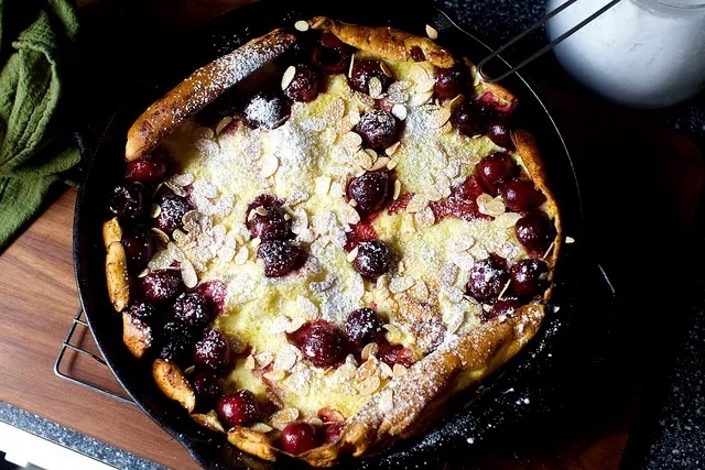 A Dutch baby pancake in a cast iron skillet
