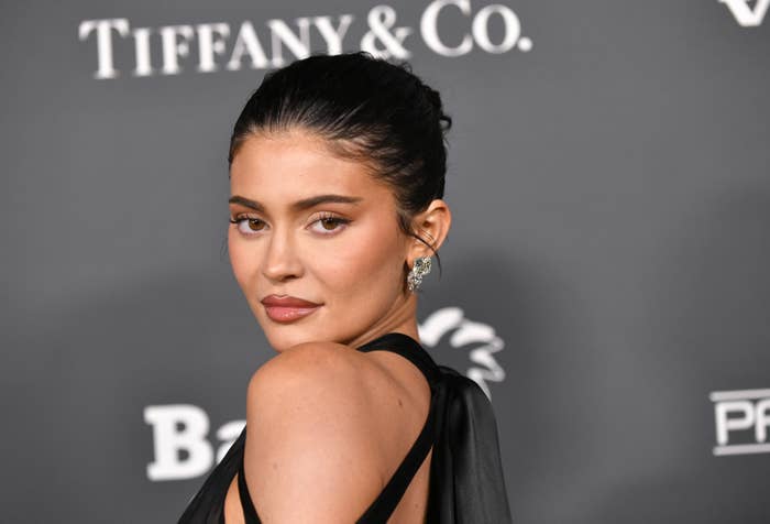 closeup of kylie at an event looking over her shoulder at the camera on the red carpet