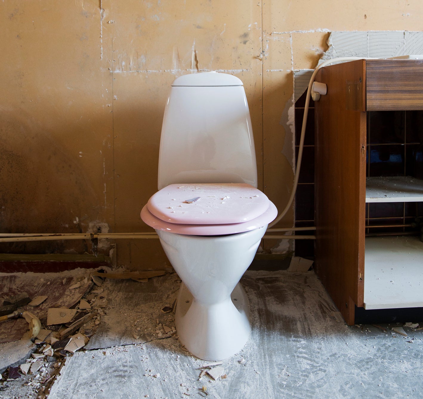 toilet in a demolished bathroom