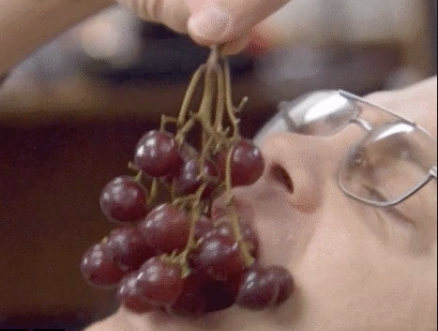 A person eating grapes