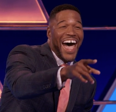 Michael Strahan laughing and pointing