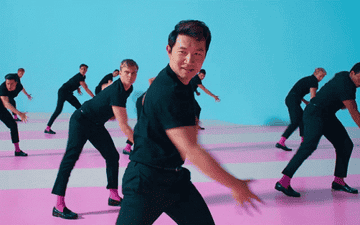 A group of Ken in all-black clothing dance in sync