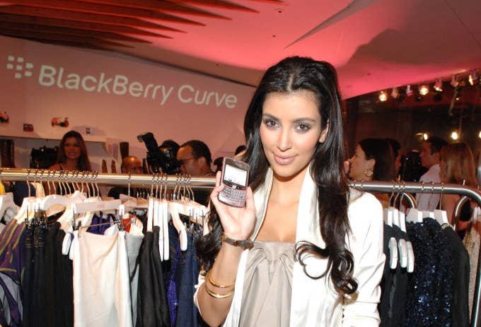 Kim Kardashian holding a Blackberry phone