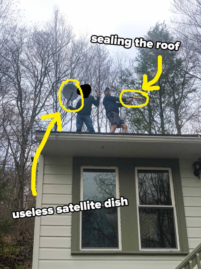 author on the roof of a house holding a caulk gun to seal the roof and take out a useless satellite dish