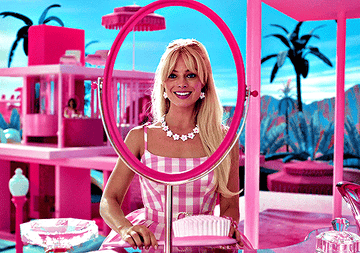 Barbie smiles into a non-existent mirror