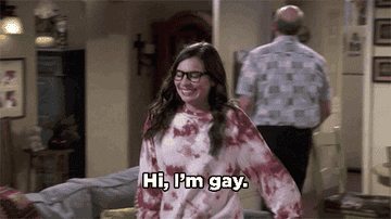 A woman walking to a man while saying &quot;HI, I&#x27;m gay&quot;