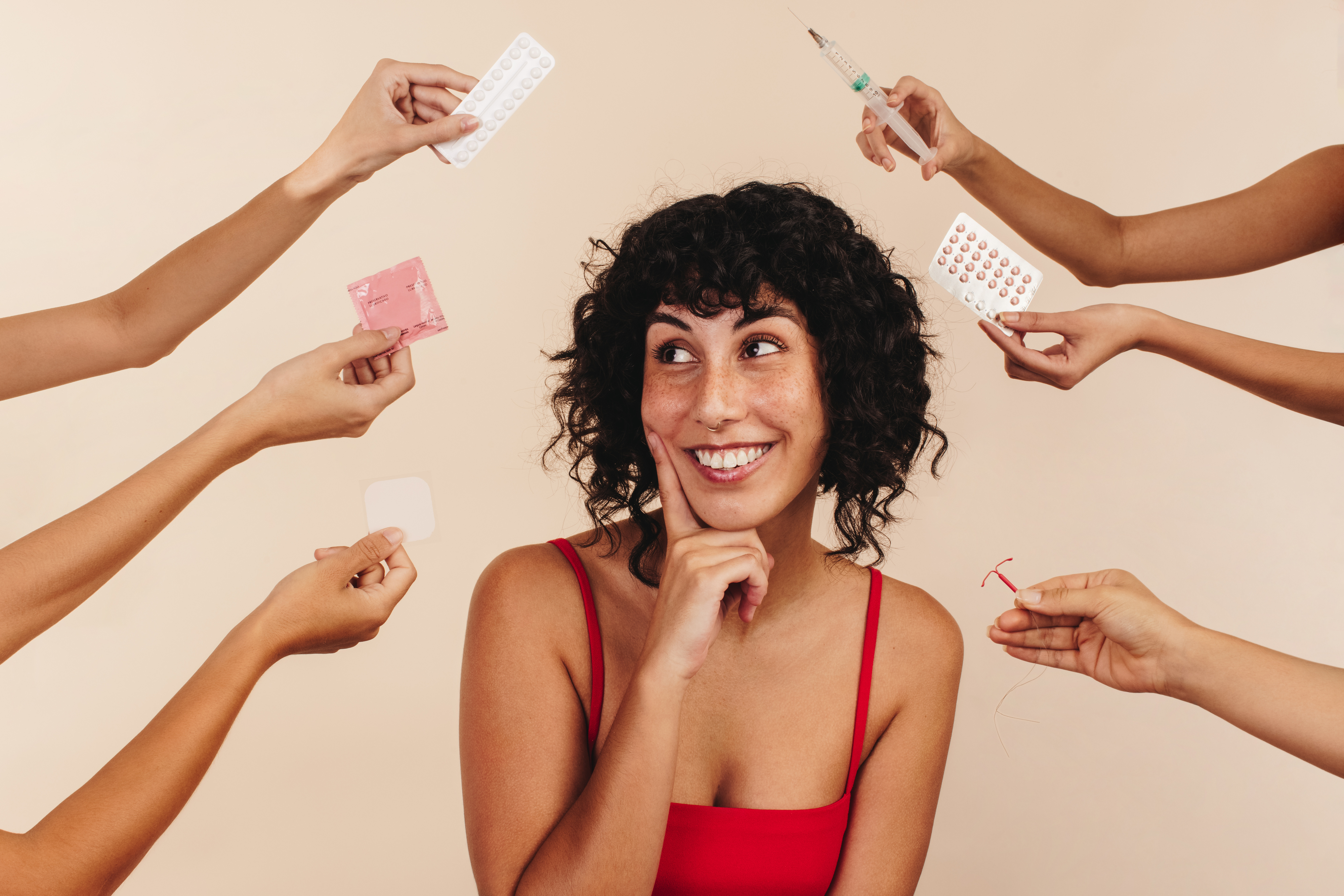 A woman being offered an assortment of contraceptives