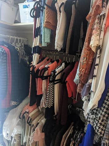 the adjustable hanging rod with hanging shirts in a closet