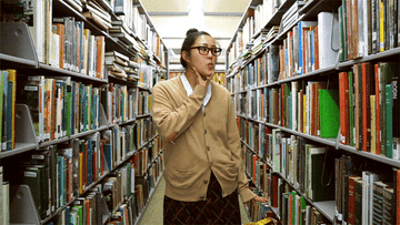woman reshelving library books