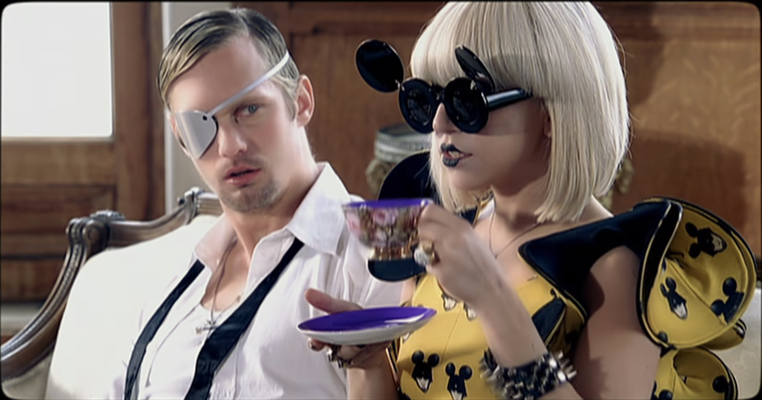Lady Gaga sipping tea in her &quot;Paparazzi&quot; music video with Alexander Skarsgård sitting next to her