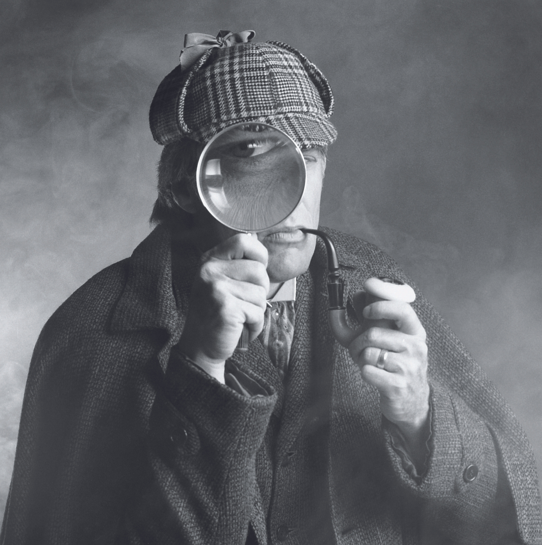 A Sherlock Holmes–type figure holding up a magnifying glass to their face and smoking a pipe