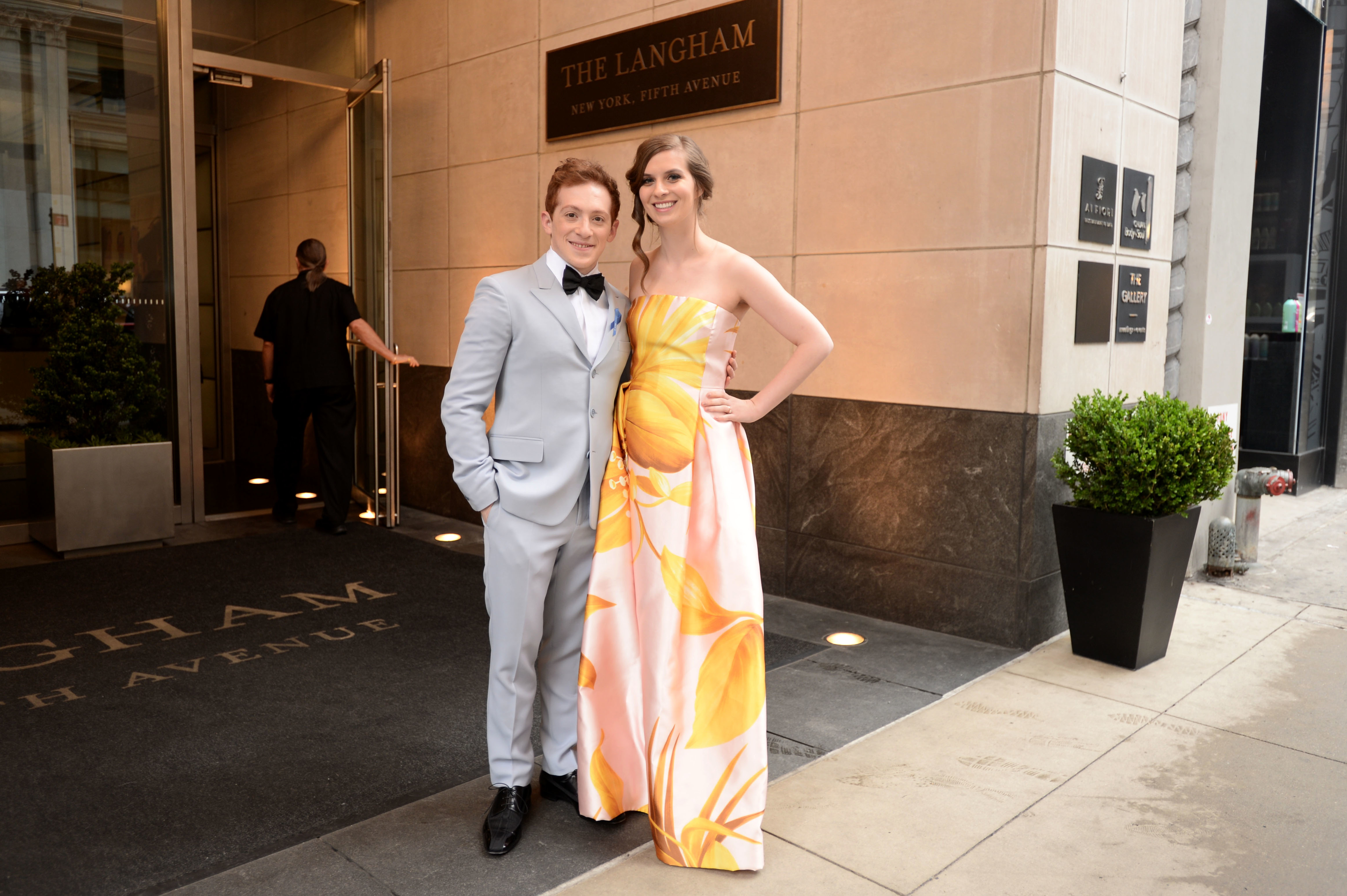 The estranged couple smile for a photo outside the Langham hotel before an event