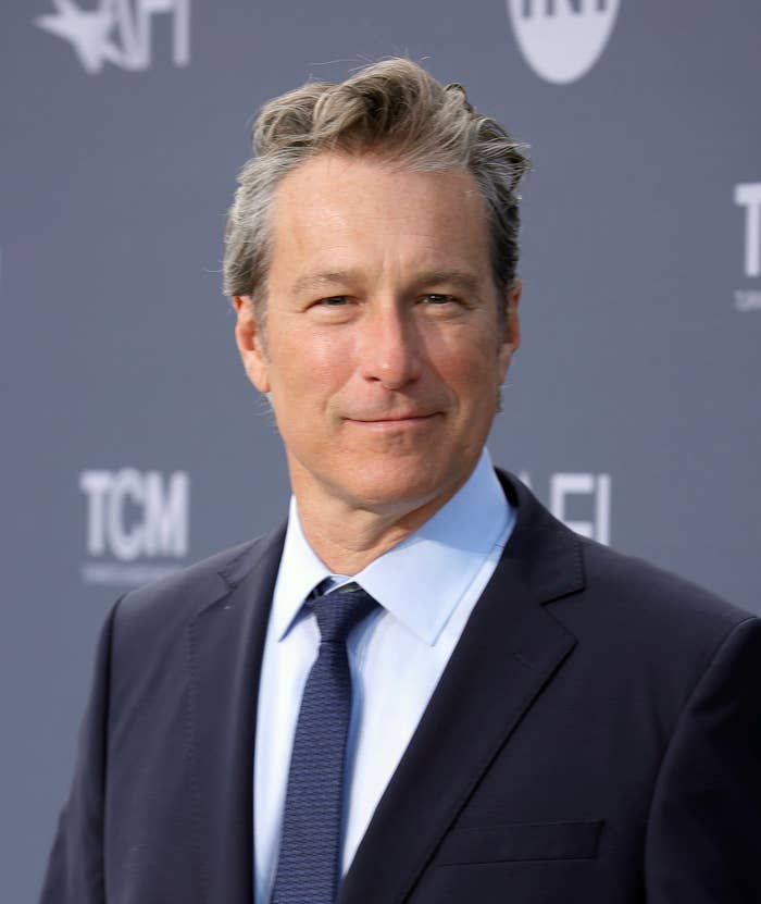 A close-up of John Corbett in a suit and tie at a media event
