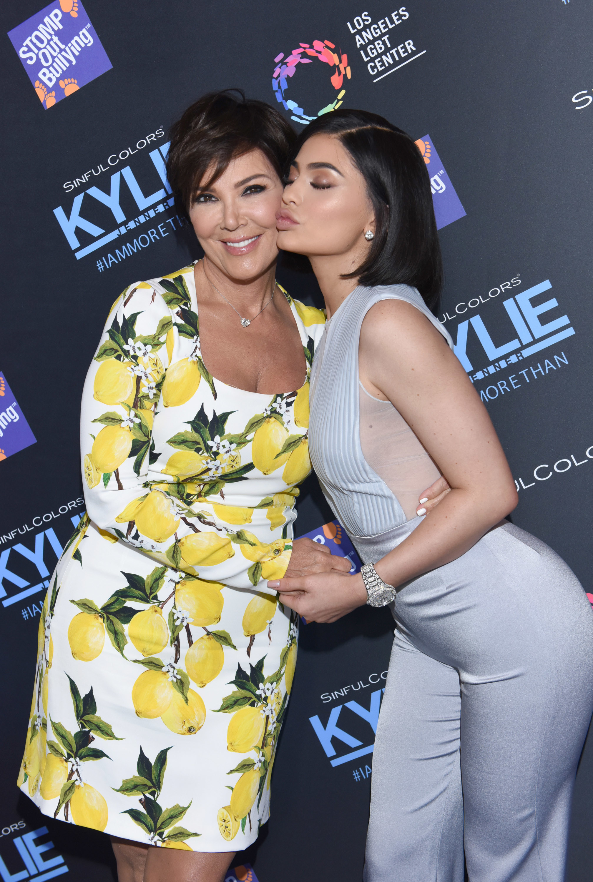 Close-up of Kris and Kylie touching cheeks at a media event