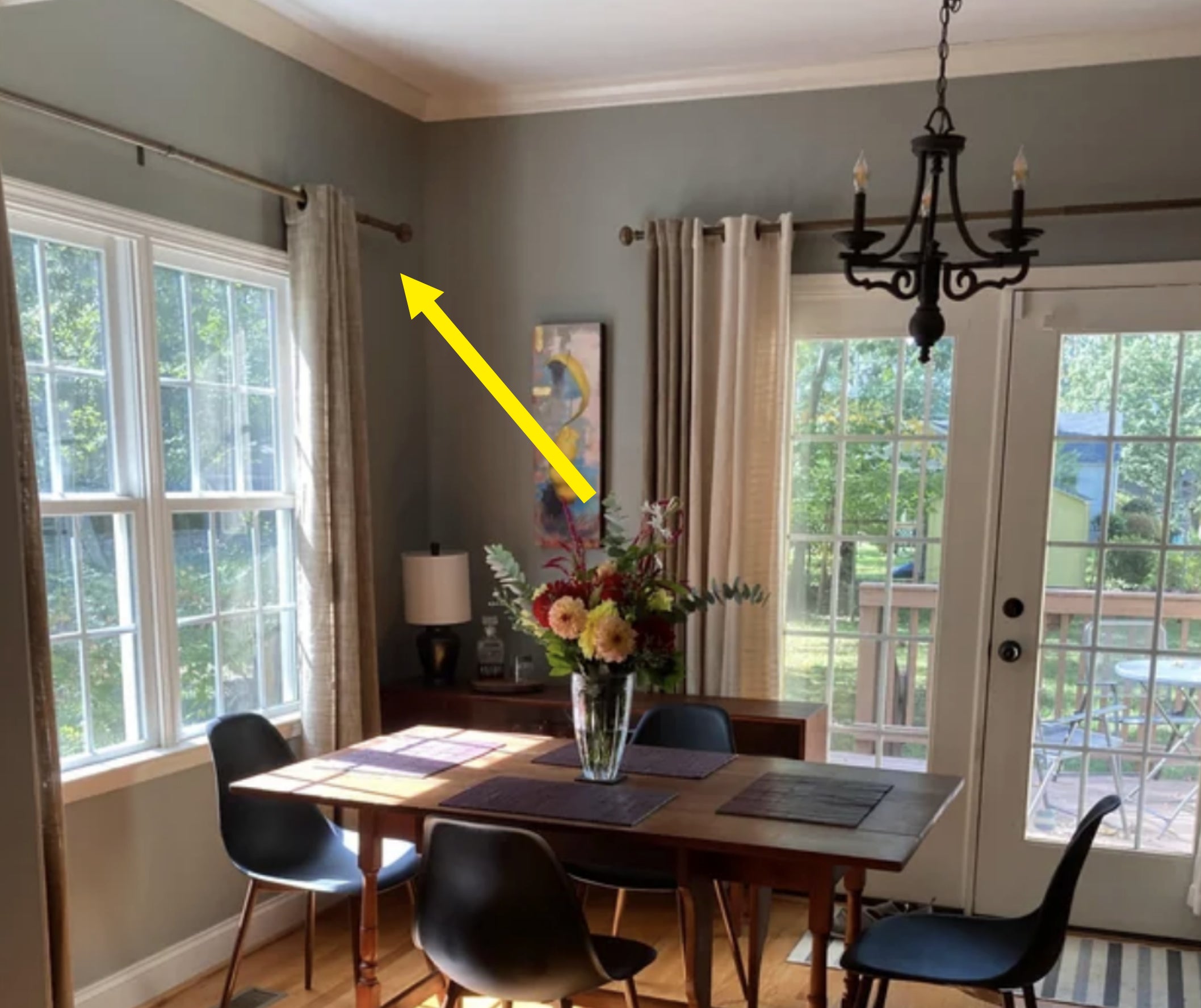 Arrow pointing to curtain rods that frame the window