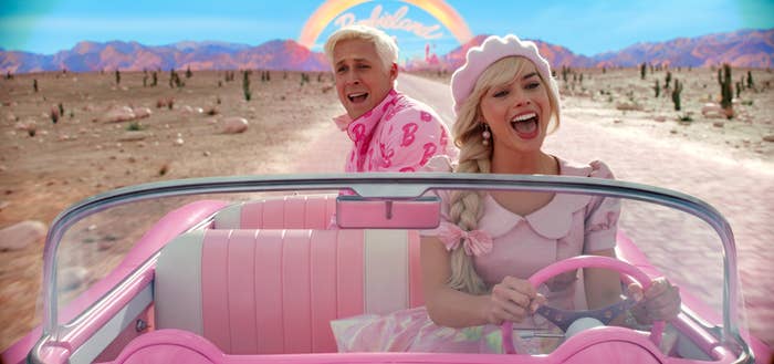 Ryan Gosling as Ken and Margot Robbie as Barbie in a pink car
