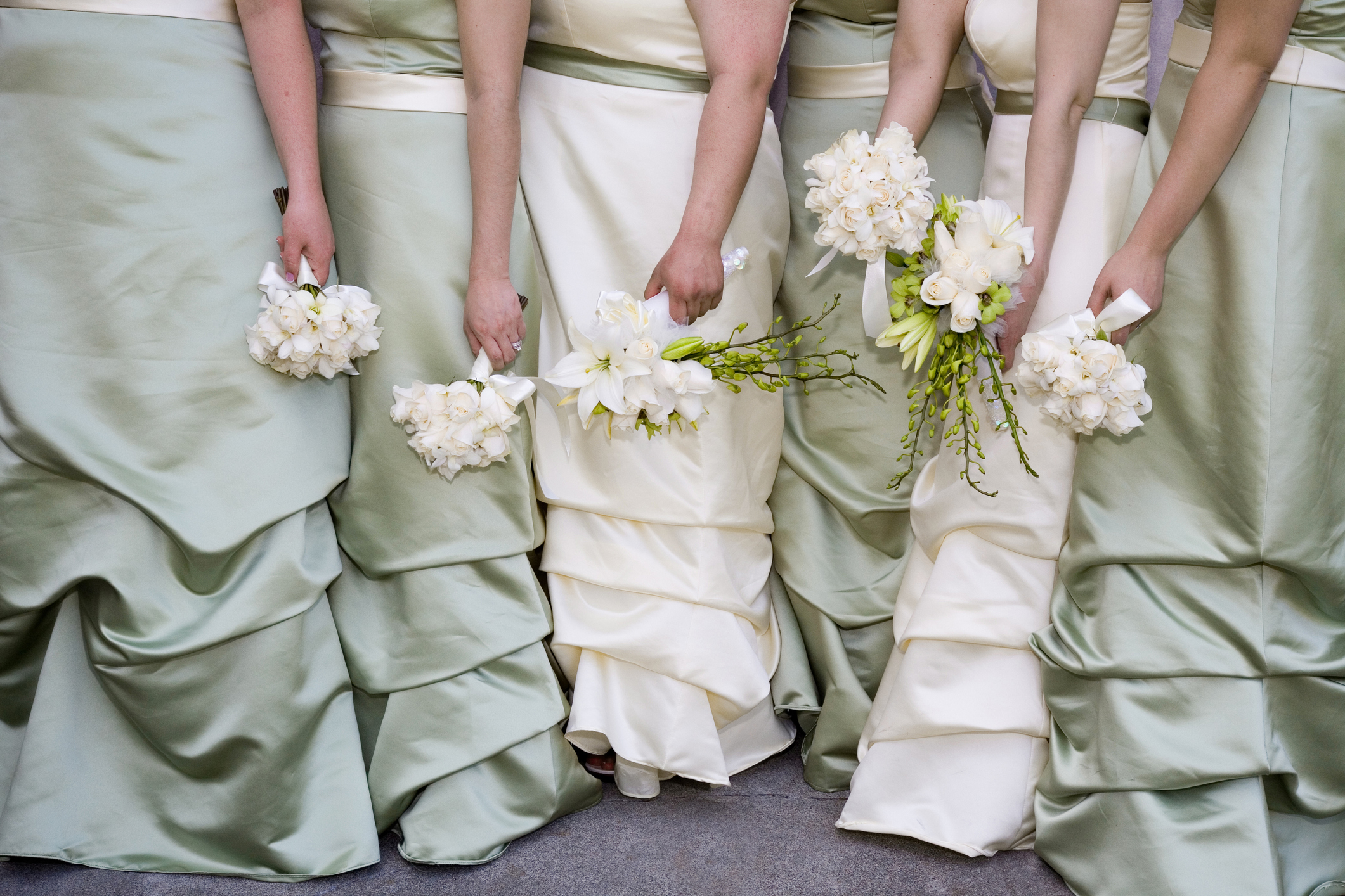 Bridesmaids in a row holding flowers