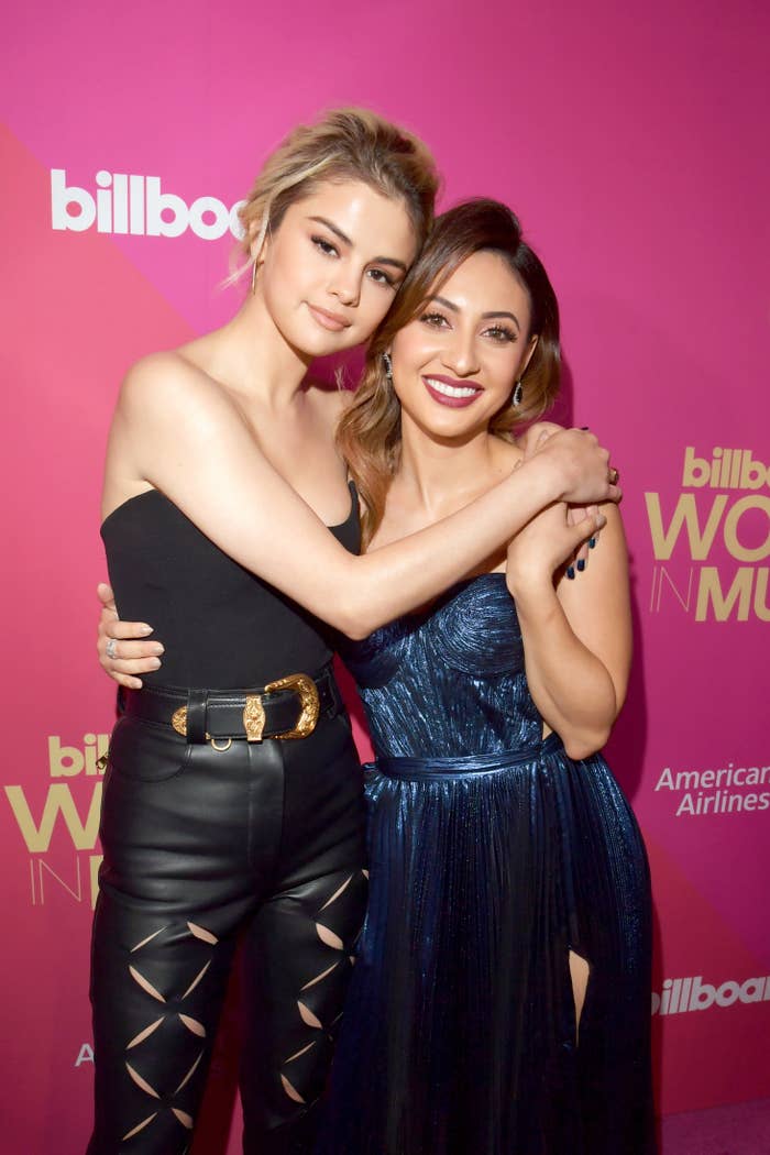 Selena Gomez and Francia Raisa with their arms around each other as they smile for a picture at a media event