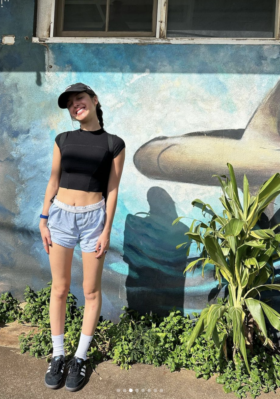 olivia posing by a mural