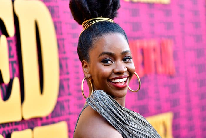 Teyonah Parris smiles while on the red carpet