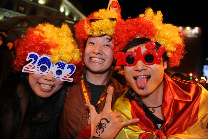 People celebrating the New Year wearing 2012 glasses