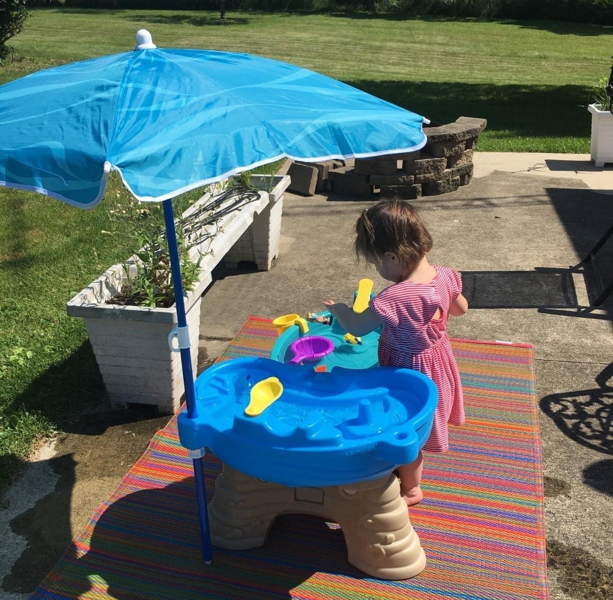 a reviewer photo of a child playing with the water table