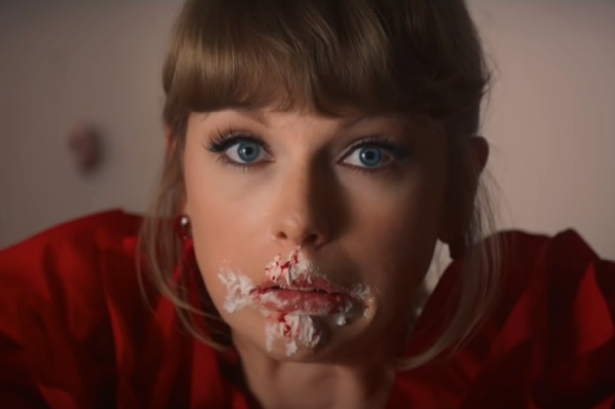 Taylor Swift with red velvet cake all over her face in the I Bet You Think About Me music video