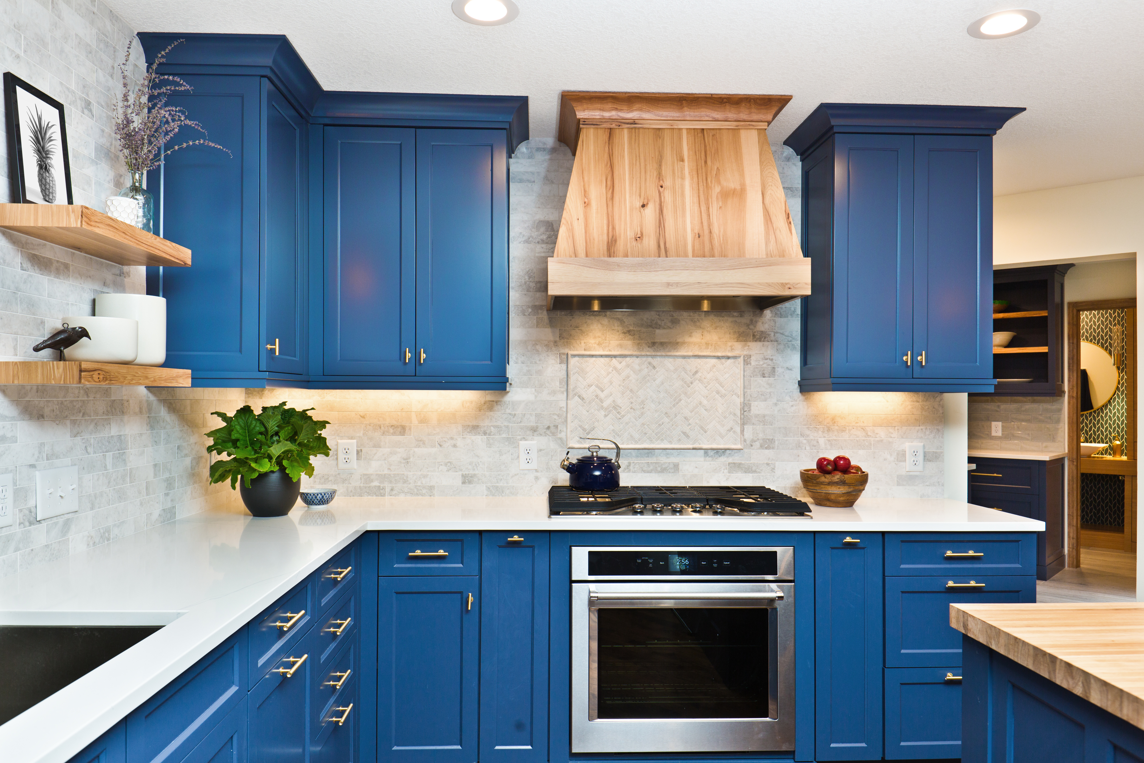 A kitchen with blue cabinets and modern accents