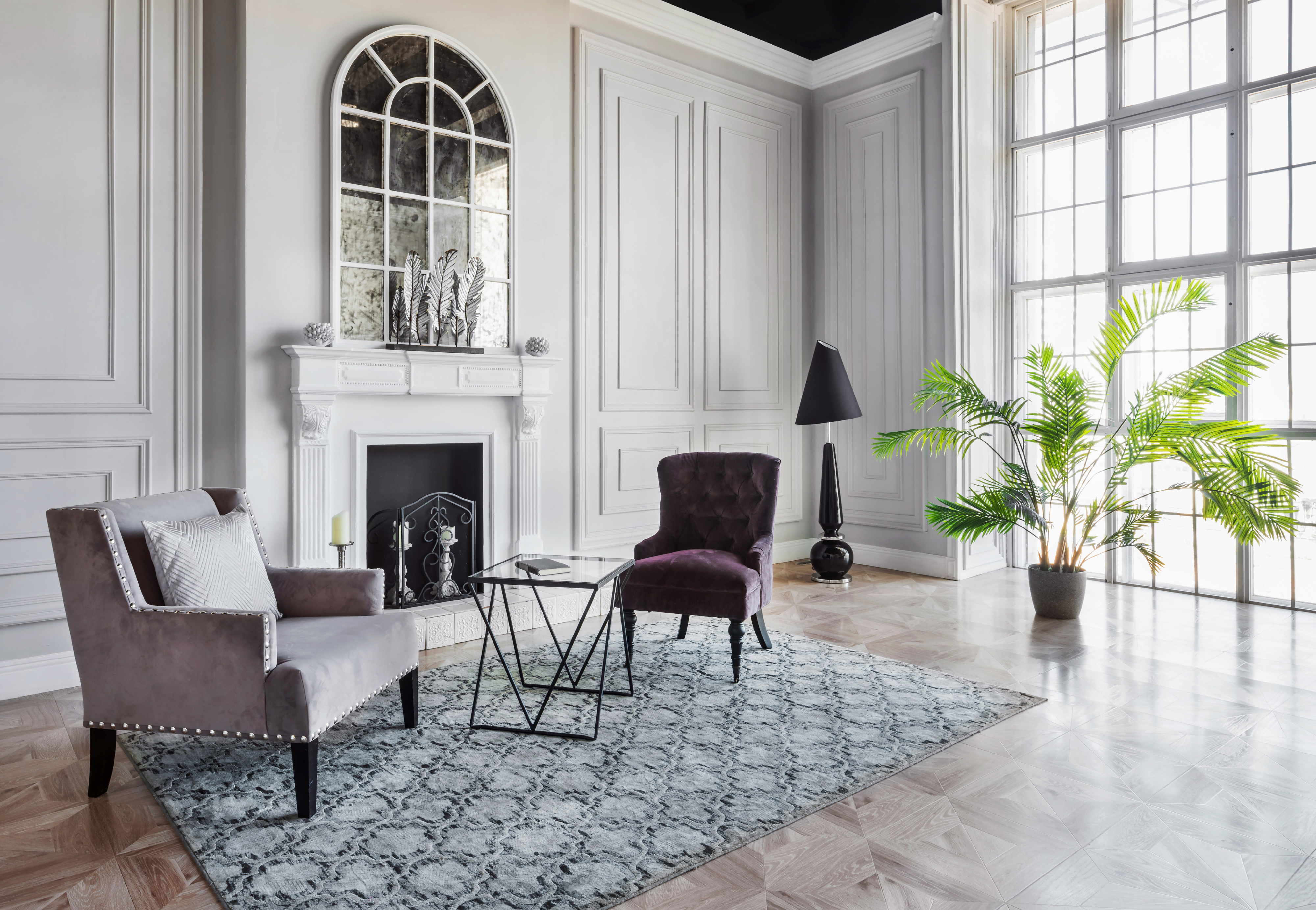 Loft area with two chairs, a table, plant and fireplace